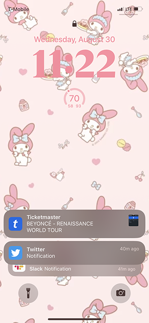 screenshot of a pink iphone lockscreen.